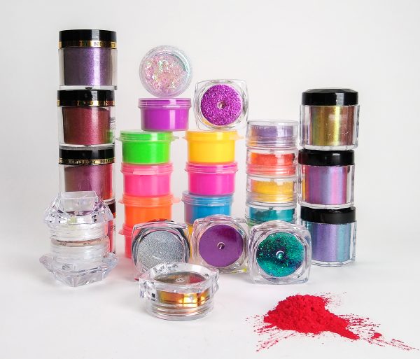 assortment of small vials and jars of nail powder